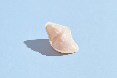 Traditional portuguese egg yolk sweets Ovos Moles de Aveiro on blue background. Confectionery shop