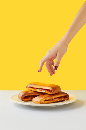 Lanche misto traditional portuguese sandwich with cheese and chorizo. Tasty breakfast over yellow background.の写真素材