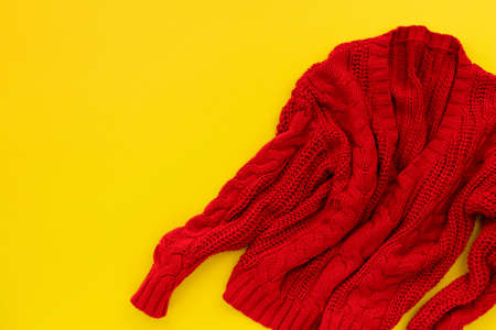 Womens red sweater on yellow background. Flat lay top viewの写真素材
