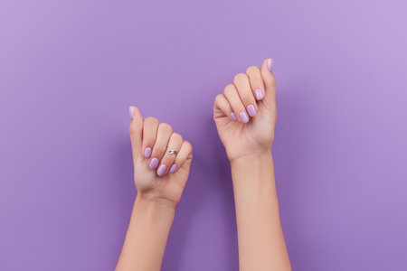 Womans hands with trendy lavender manicure. Spring summer nail designの写真素材