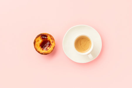 Traditional Portuguese egg tart dessert Pasteis Pastel de nata or Pasteis de Belem with coffee over pink background.の写真素材