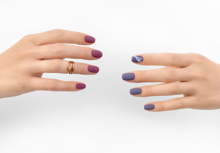 Beautiful purple burgundy matte manicure on white backgroundの写真素材