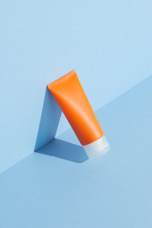 Sunscreen lotion on blue background with copy space. Body care beauty treatment conceptの写真素材