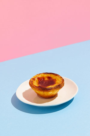 Traditional Portuguese egg tart dessert Pasteis Pastel de nata or Pastels de Belem on the plate over...