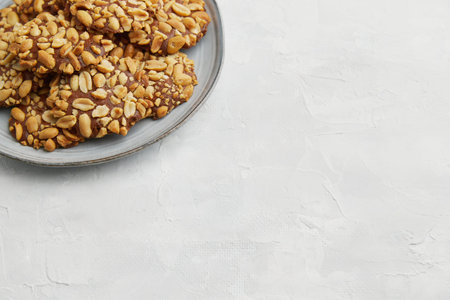 A heap of Portugues traditional peanut cookies known as Bolachas de Amendoim on the grey plate