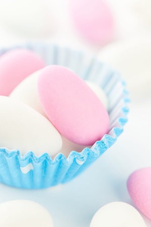 Traditional Easter Portuguese candies. Colorful Sweets in a blue paper cup on a white background