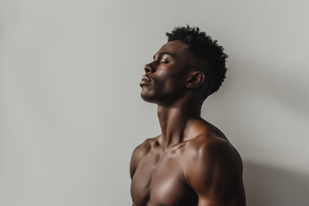 Profile photo of young hadsome African American man against gray background with space for textの素材