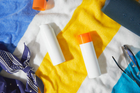 Sunscreen lotion on beach towel. Care products summer accessories