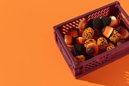 Candy in box on orange background. Halloween sale conceptの写真素材