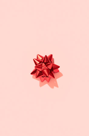 Postcard wallpaper with red bow on pink in minimal style. Holiday backgroundの写真素材