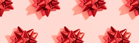 Creative Christmas pattern with red bow on pink. Xmas holiday backgroundの写真素材