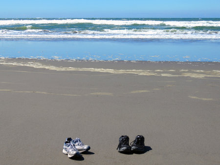 Two pair of shoes  on a  sandy beach.の写真素材