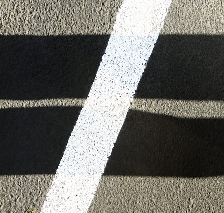 Shadows and white stripe form a not-equal-to sign.