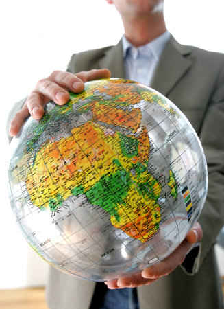 Businessman holding a globe 