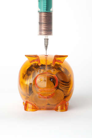 Piggy bank with syringe - financial crisis conceptの写真素材