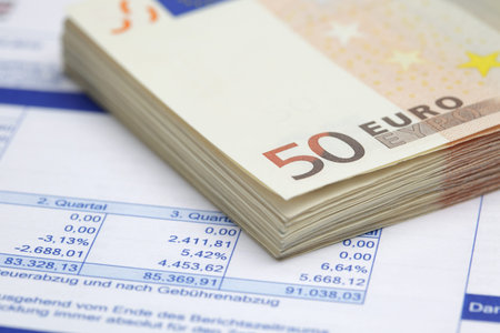Stack of Euro bills on financial report