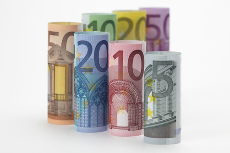 Rolled up Euro bills on white backgroundの写真素材