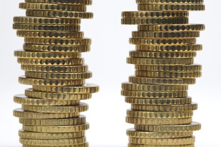 Coin stacks, close-up on white backgroundの写真素材