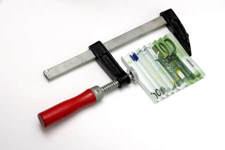 One hundred euro bill squeezed in a clamp の写真素材