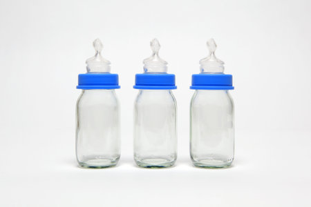 Three empty baby bottles in a row