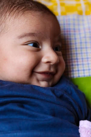 close up of cute baby boy smiling. selective focus. noise to artistic look.の写真素材