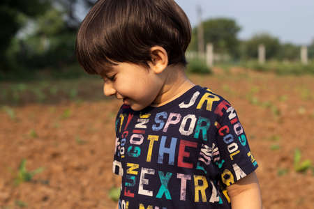 Indian cute baby boy in farmの写真素材
