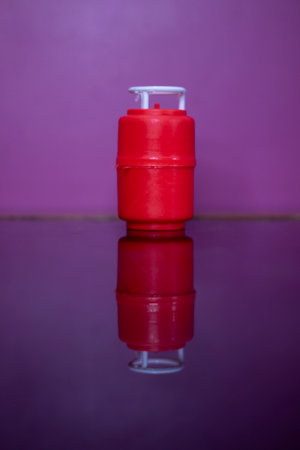 Red colored gas container on table, plastic toyの写真素材
