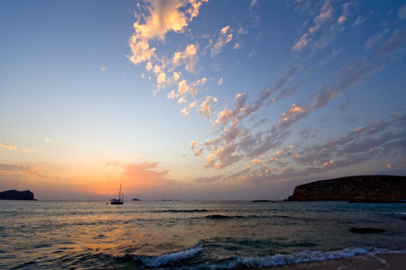 sailboat at sunset with impressing cloud formations off the western coast of Ibiza の写真素材