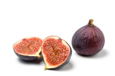 a whole and a halved fig isolated on white backgroundの写真素材