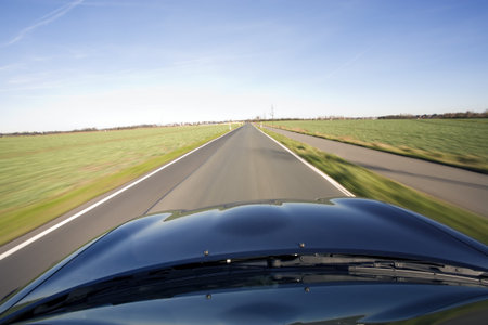 view from bluesportscar in fast motion onto a rural road