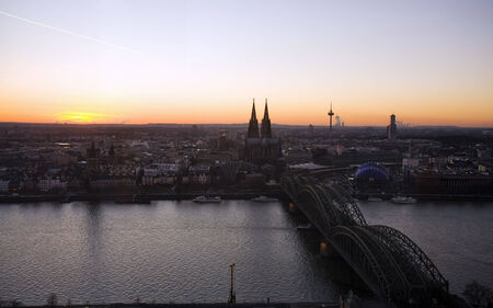 view at cologne with Rhine river, Hohenzollern bridge and cathedral at sunsetの写真素材