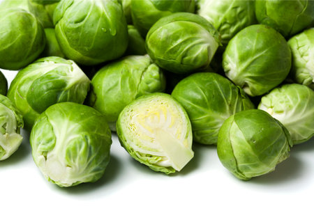 pile of brussels sprouts, halved one in front