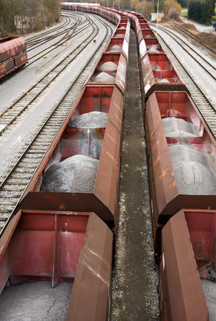 wagons on rails waiting, loaded with mineral sand