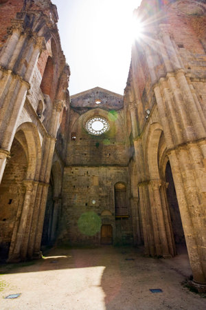 View through the missing roof of the Abbey of San Galgano into the bright sunlight  Lens flare on purposeのeditorial素材
