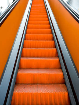 orange escalator, view upwardsの写真素材