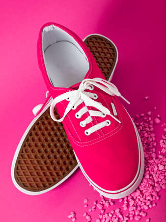 pink sneakers on purple backgroundの写真素材