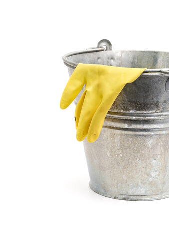 rubber glove hanging out of tin bucket isolated on whiteの写真素材