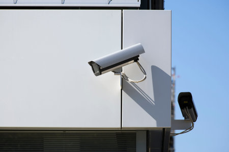 two surveillance cameras at corner of building