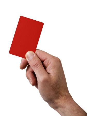 referee's hand holding red penalty card isolated on whiteの写真素材