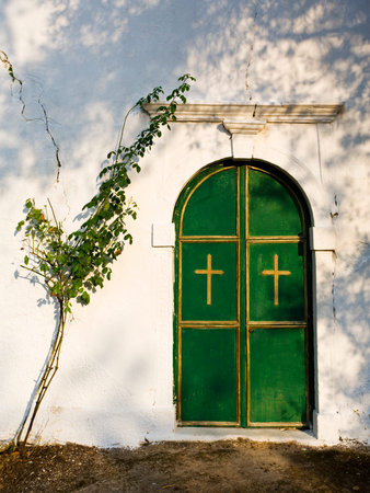 closed door of Stavromenos church at Nimfes, Corfu, Greeceの写真素材