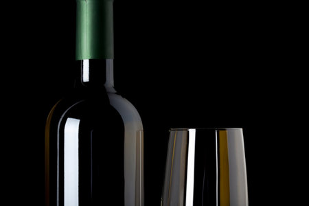 closeup of wine bottle and glass, black backgroundの写真素材