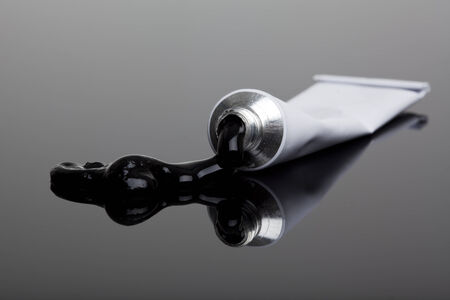 black paint flowing from a tubeの写真素材