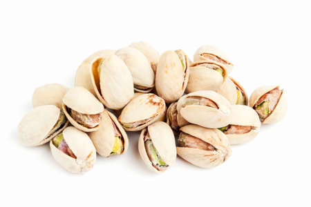 heap of pistachios isolated on whiteの写真素材