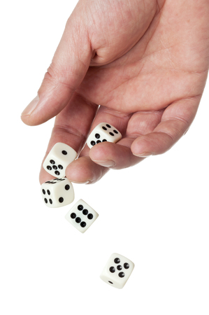 hand throwing five dice, some are mid-air, isolated on white backgroundの写真素材