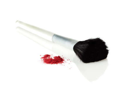 powder brush and small heap of rouge on white backgroundの写真素材