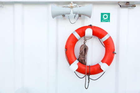 orange lifebuoy and signal horns on shipの写真素材