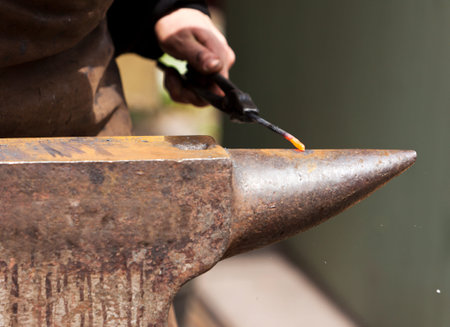 Forging red hot metal on ana anvilの写真素材