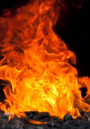 blazing flames in a blacksmith's fire pitの写真素材