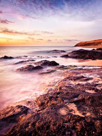 Rocky coastline of Fuerteventura in sunriseの写真素材