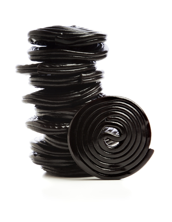 Stack of liquorice reels isolated on whiteの写真素材